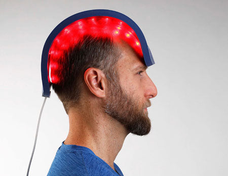 A man using Celluma's Hair Restoration LED Light Therapy Device