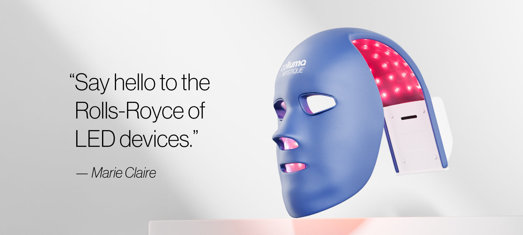 Mystique mask on the right lit up against a white background with the quote "say hello to the Rolls-Royce of LED devices" from Marie Claire on the left. 