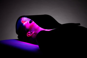 Woman using a LED Light Therapy device