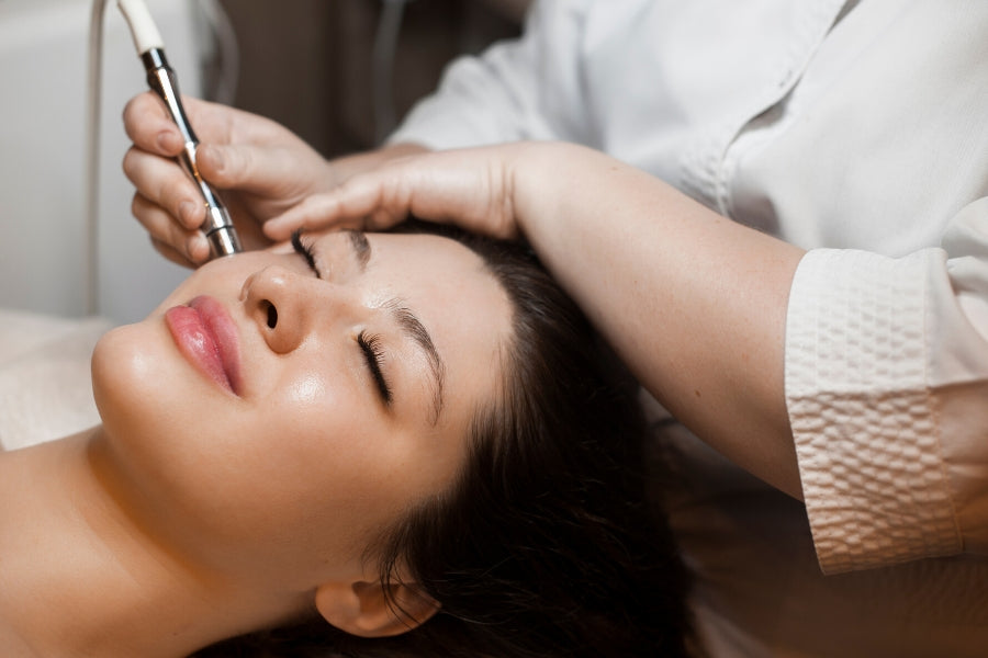 Woman receiving microneedling treatment