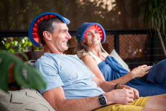 A couple using red light therapy to stimulate hair growth at home