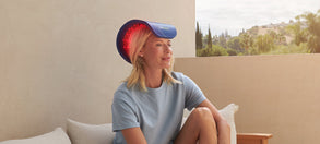 Woman sitting outside on a patio with a Celluma RESTORE on her head.