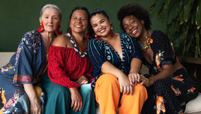 Group of diverse women with alopecia smiling and sitting together on a couch