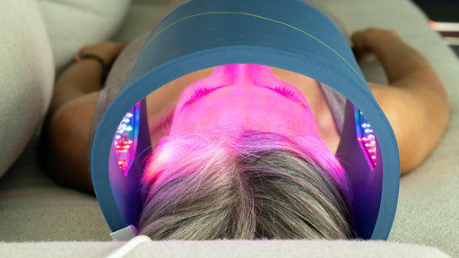 Woman Using Celluma Light Therapy Device in Living Room