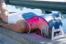 Woman using Celluma aging products outside near pool