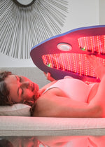 Woman using a full-body Celluma device