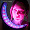 Woman holding an FDA-cleared Celluma NOVA led low-level light therapy device with multi-wavelength technology utilizing red light, near-infrared light, and blue light energy.