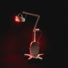 The Celluma ELITE series 2 professional LED red light therapy machine being used on CONTOUR mode for body contouring.  Image shows the machine's mobile base, flexible arms and rotating panel.